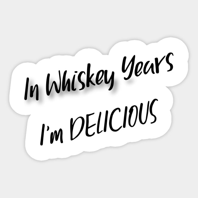 In Whiskey Years I'm Delicious Sticker by Cranky Goat